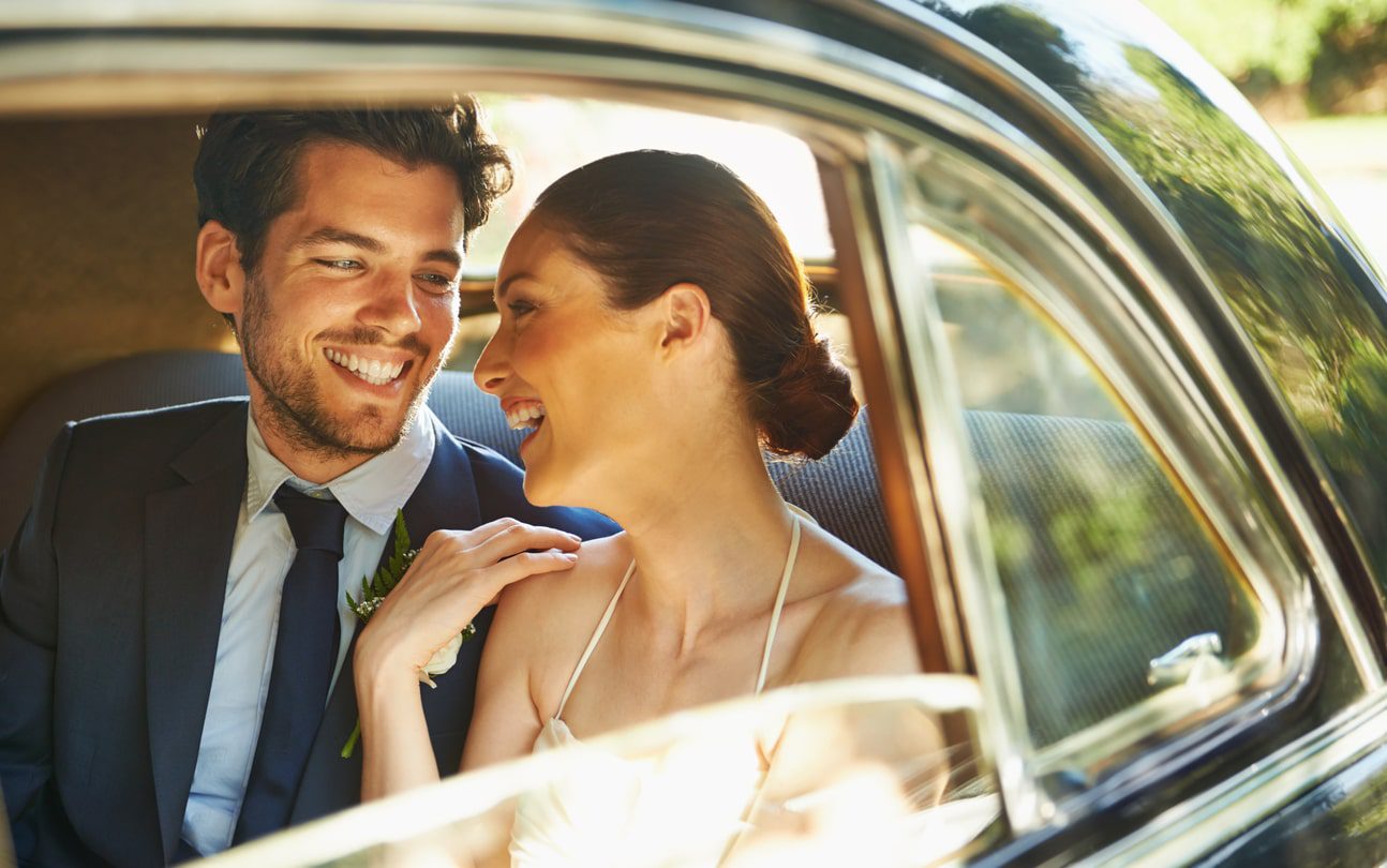 couple leaving venue after marriage in chauffeur driven car